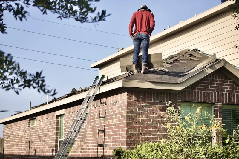 Professional roofer working on a residential roof in Myrtle Grove